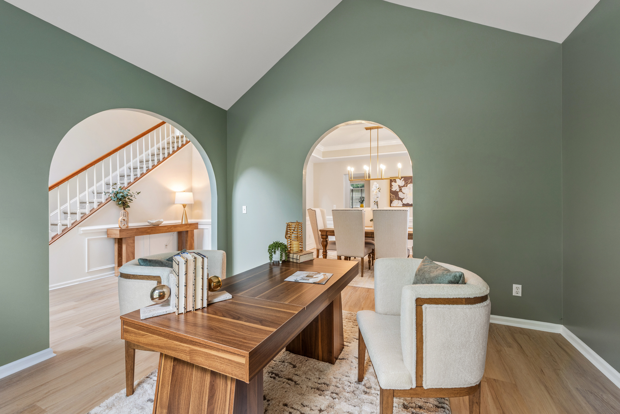 Ground-floor office space with vaulted ceiling and sage green accent walls