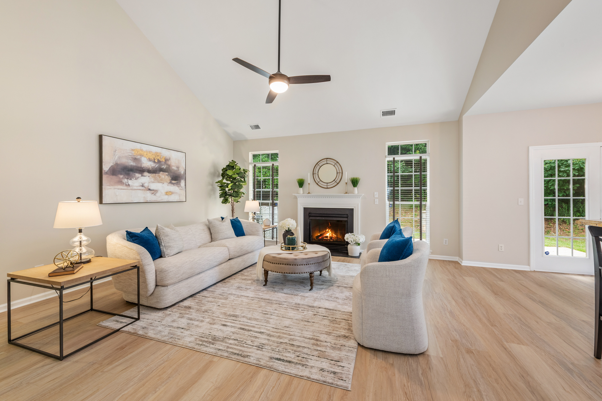 Vaulted family room with gas fireplace and rear windows flooding the space with light