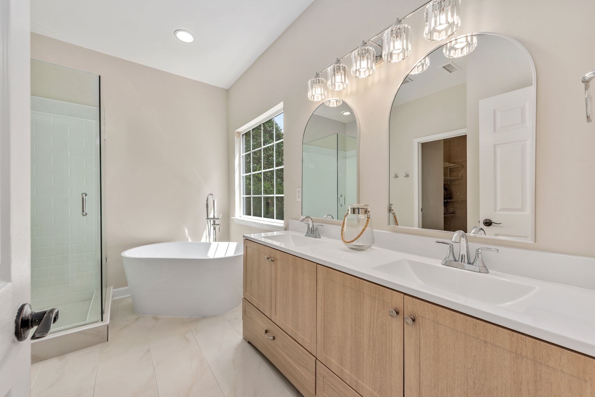 Primary bathroom with freestanding soaking tub and glass shower