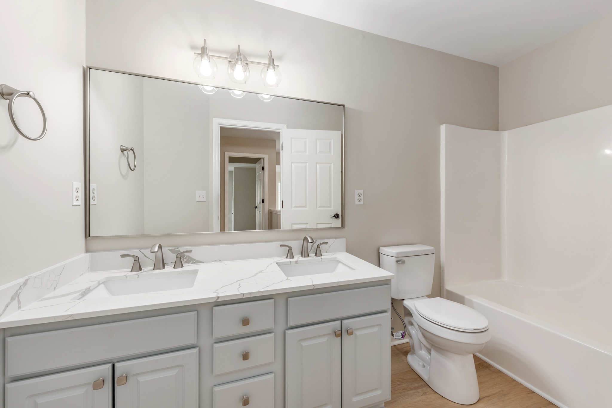 Upstairs bathroom with double-sink vanity and grey shaker cabinetry