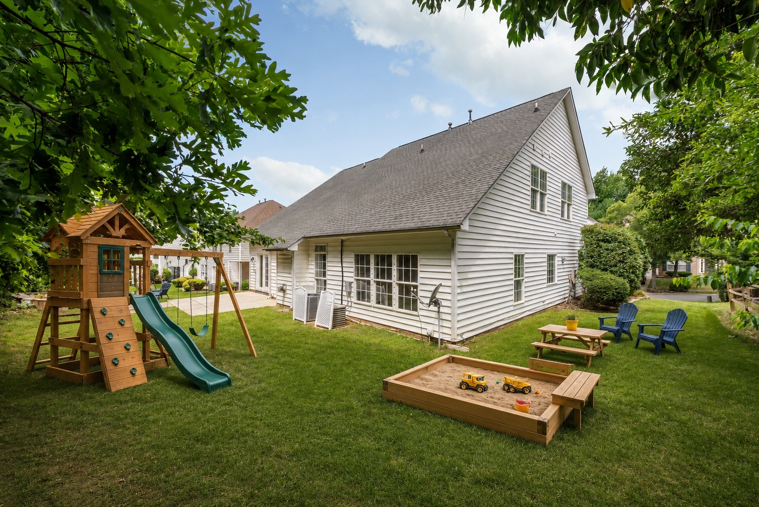Rear yard with play area and mature shade trees