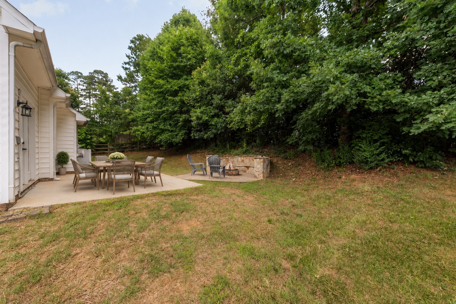 Backyard ground-level view of fire pit and patio area