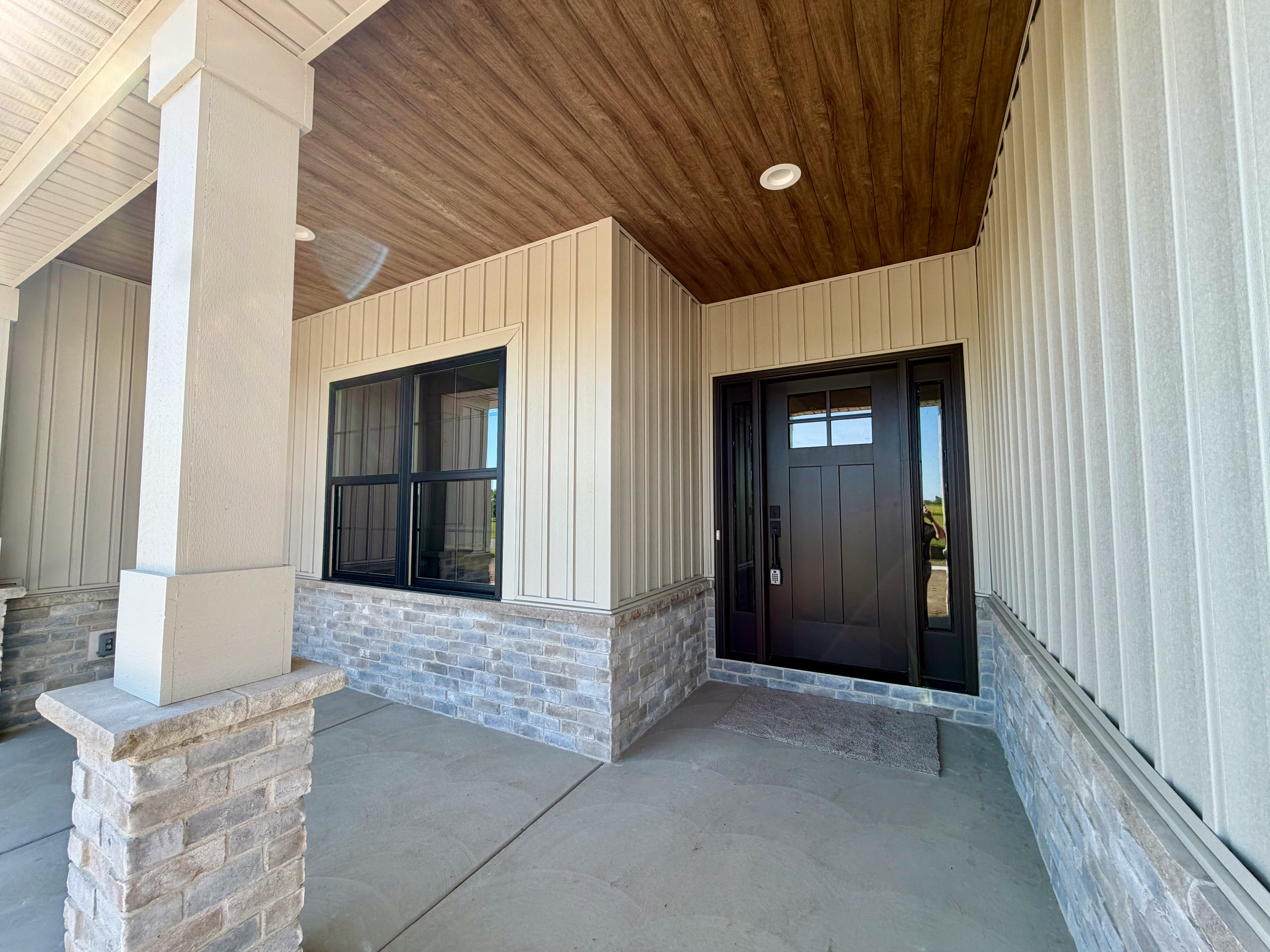 Covered front porch with board-and-batten siding and stone veneer column