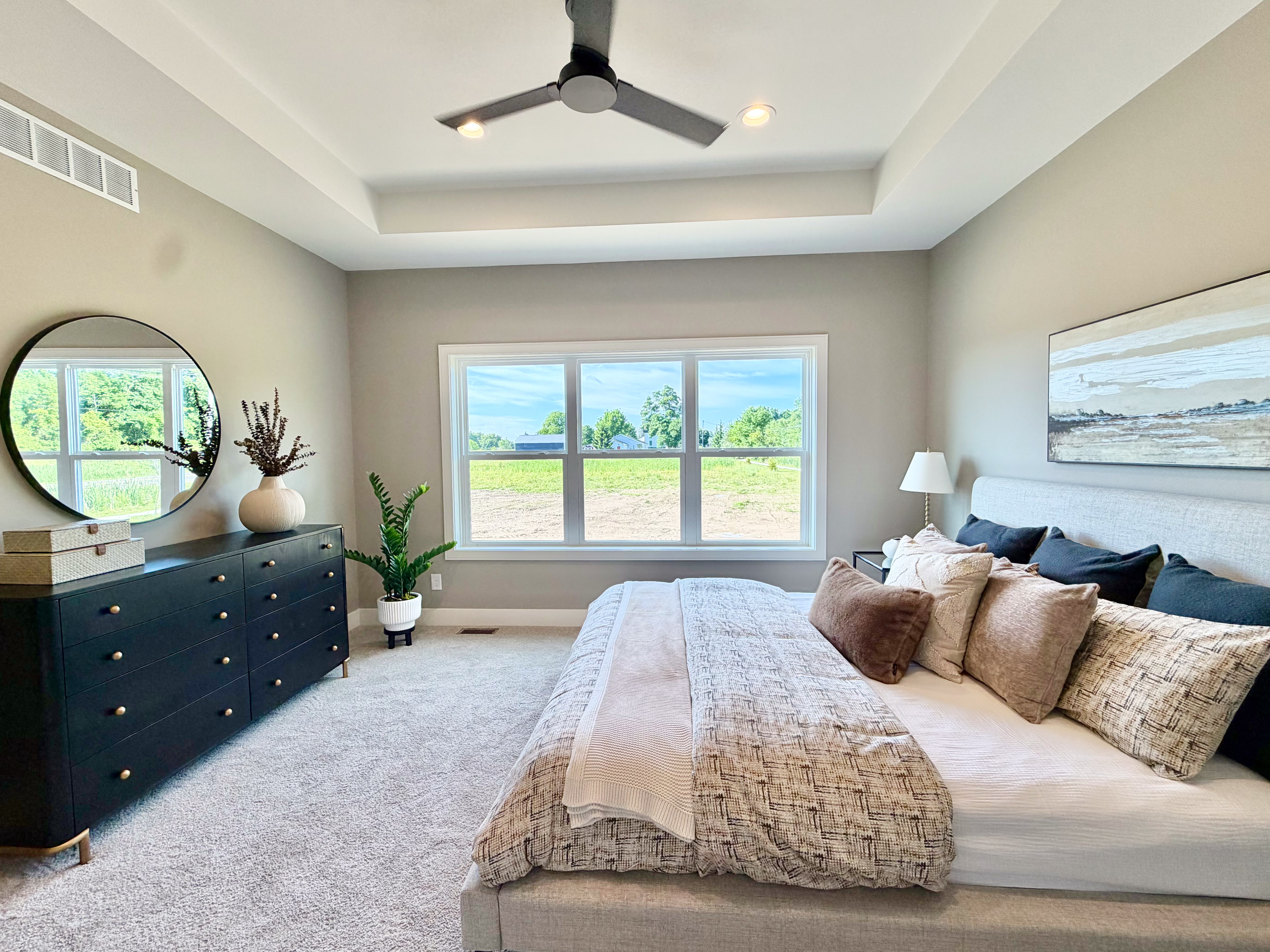 Master bedroom with neutral grey palette and expansive windows