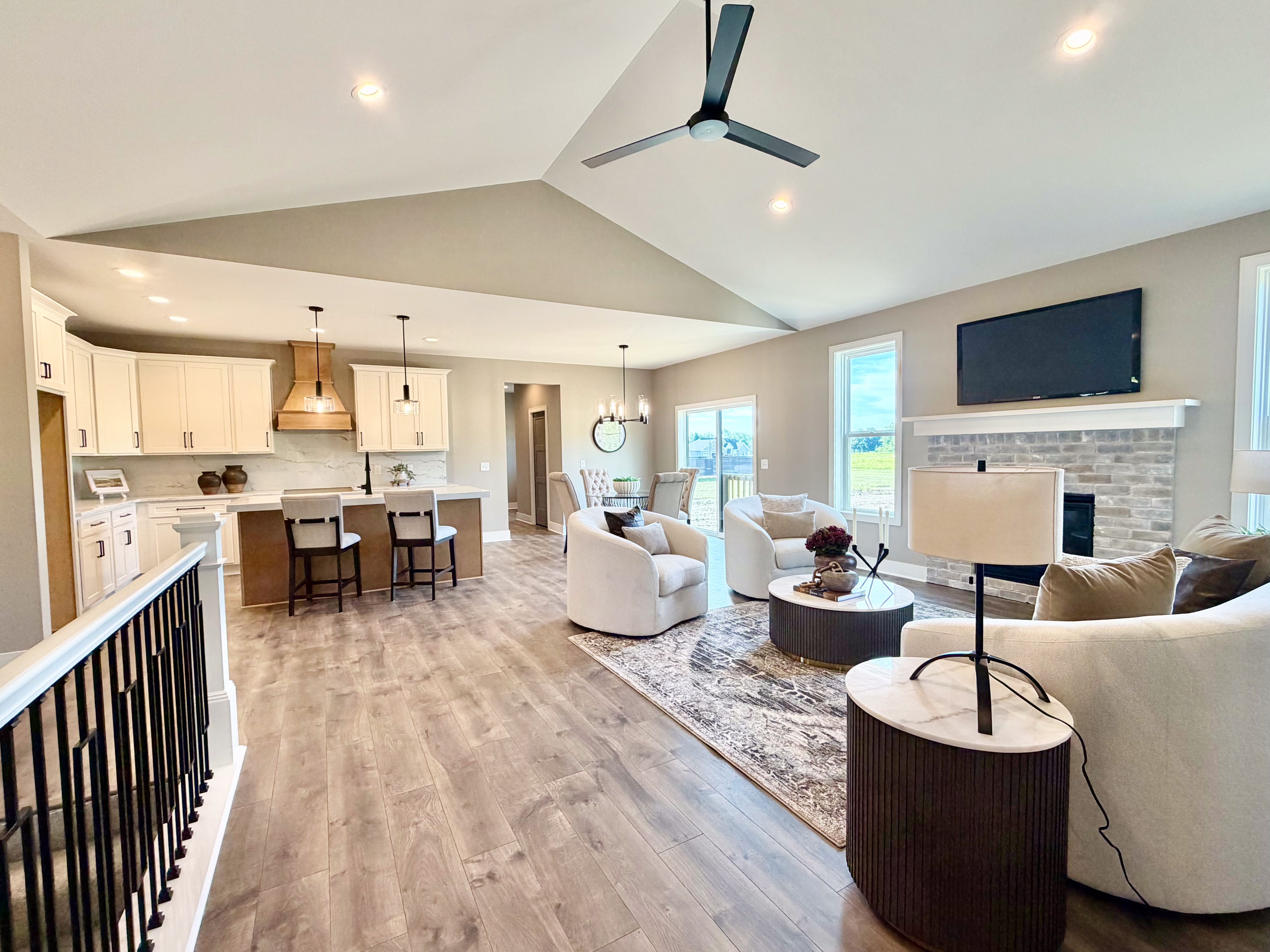 Open concept living, kitchen, and dining area with vaulted ceilings