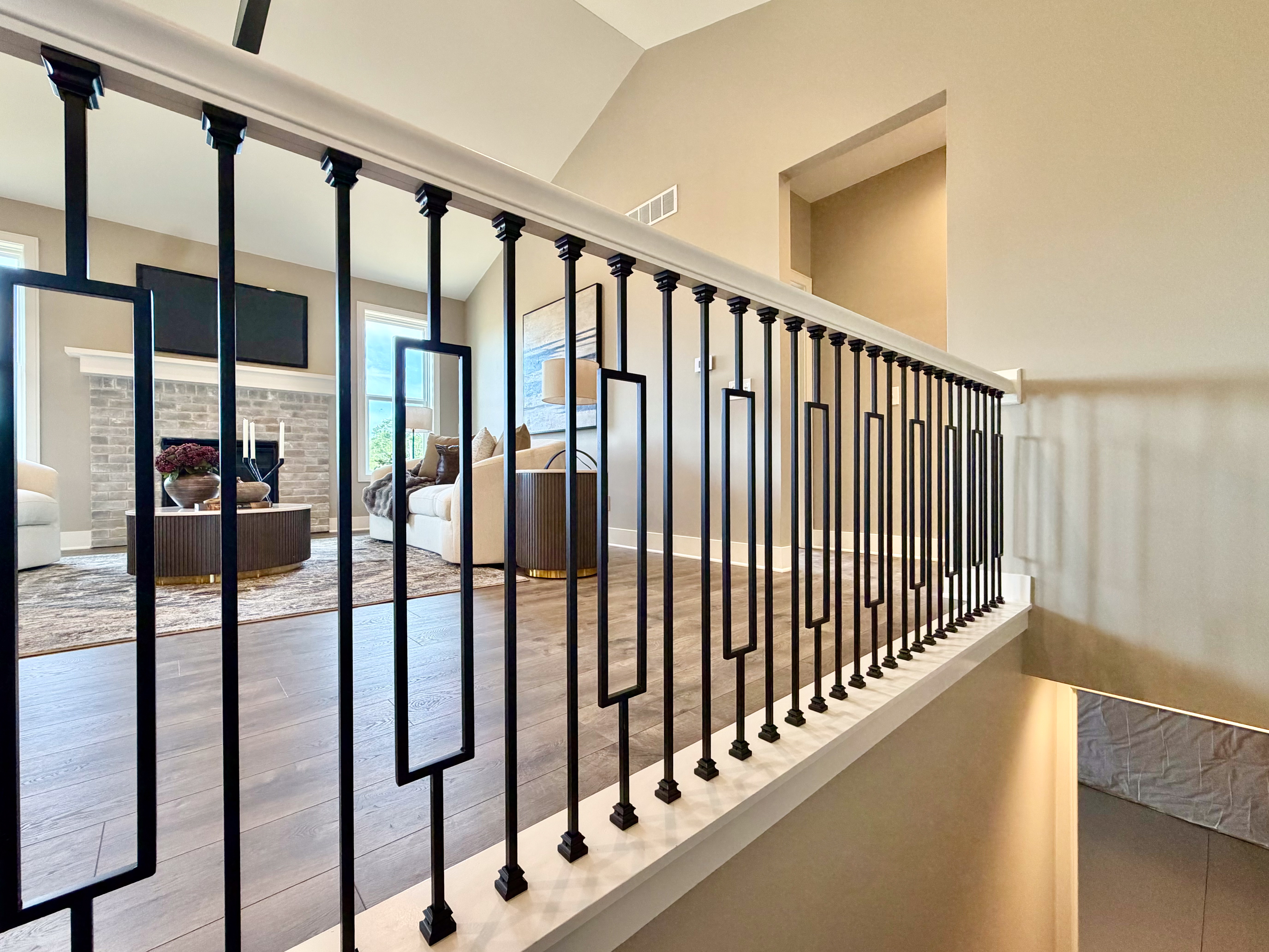 Staircase landing with view of open living room below