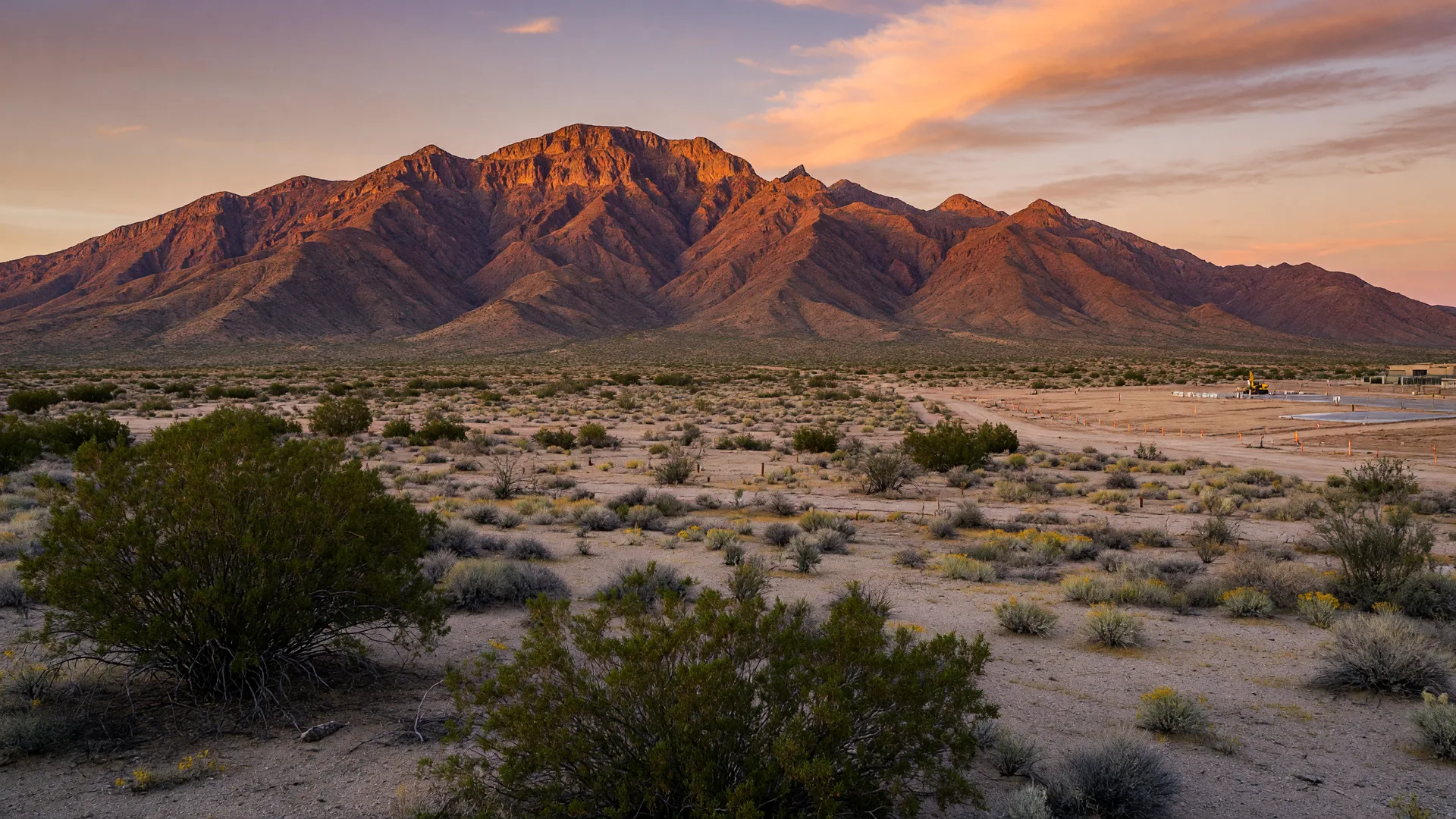 Goodyear's landscape with the Estrella Mountain range prominently in the background, wide desert vista, and west valley growth feel under open sky