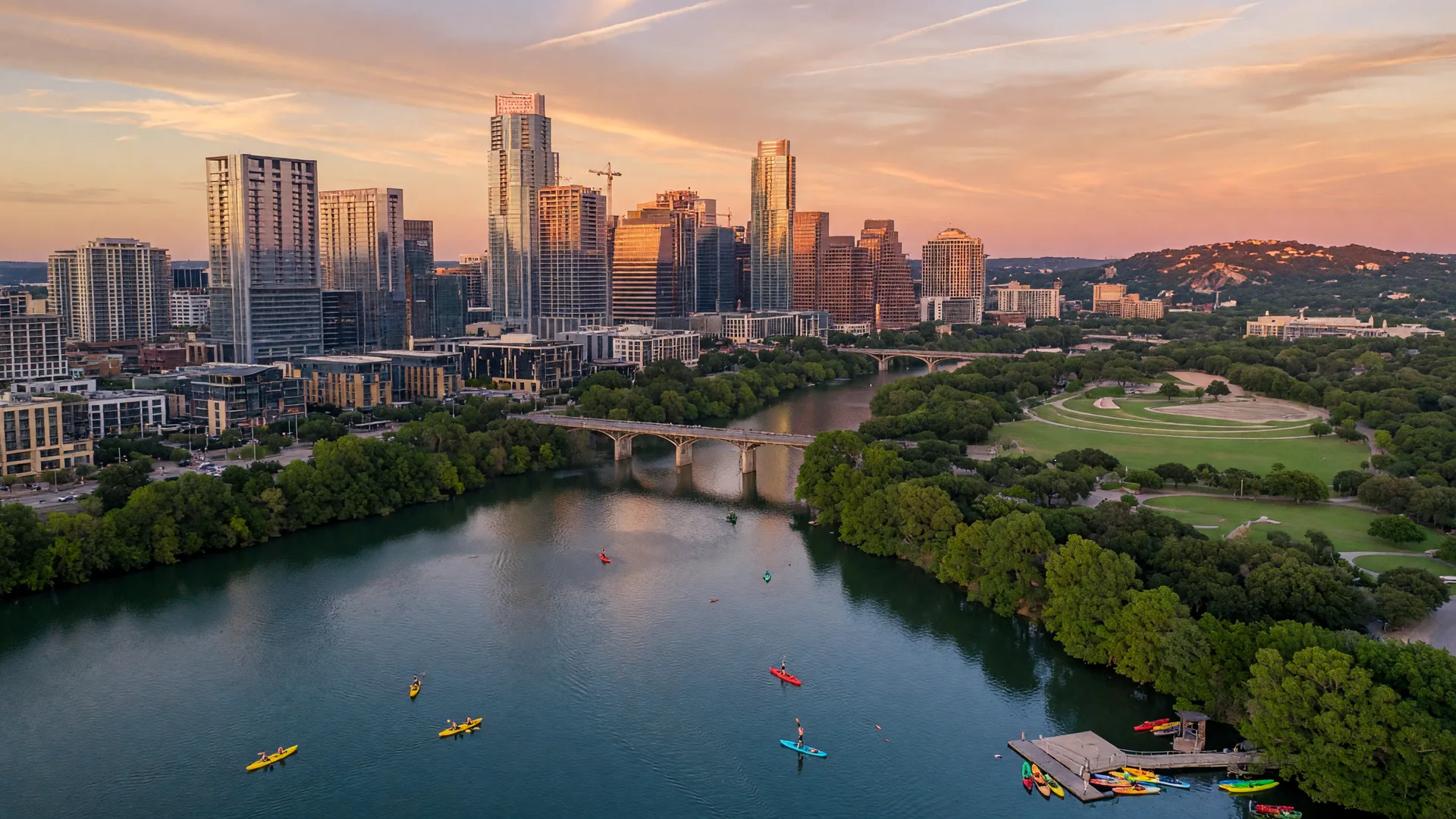 Austin Texas skyline with Lady Bird Lake and modern downtown skyscrapers at sunset