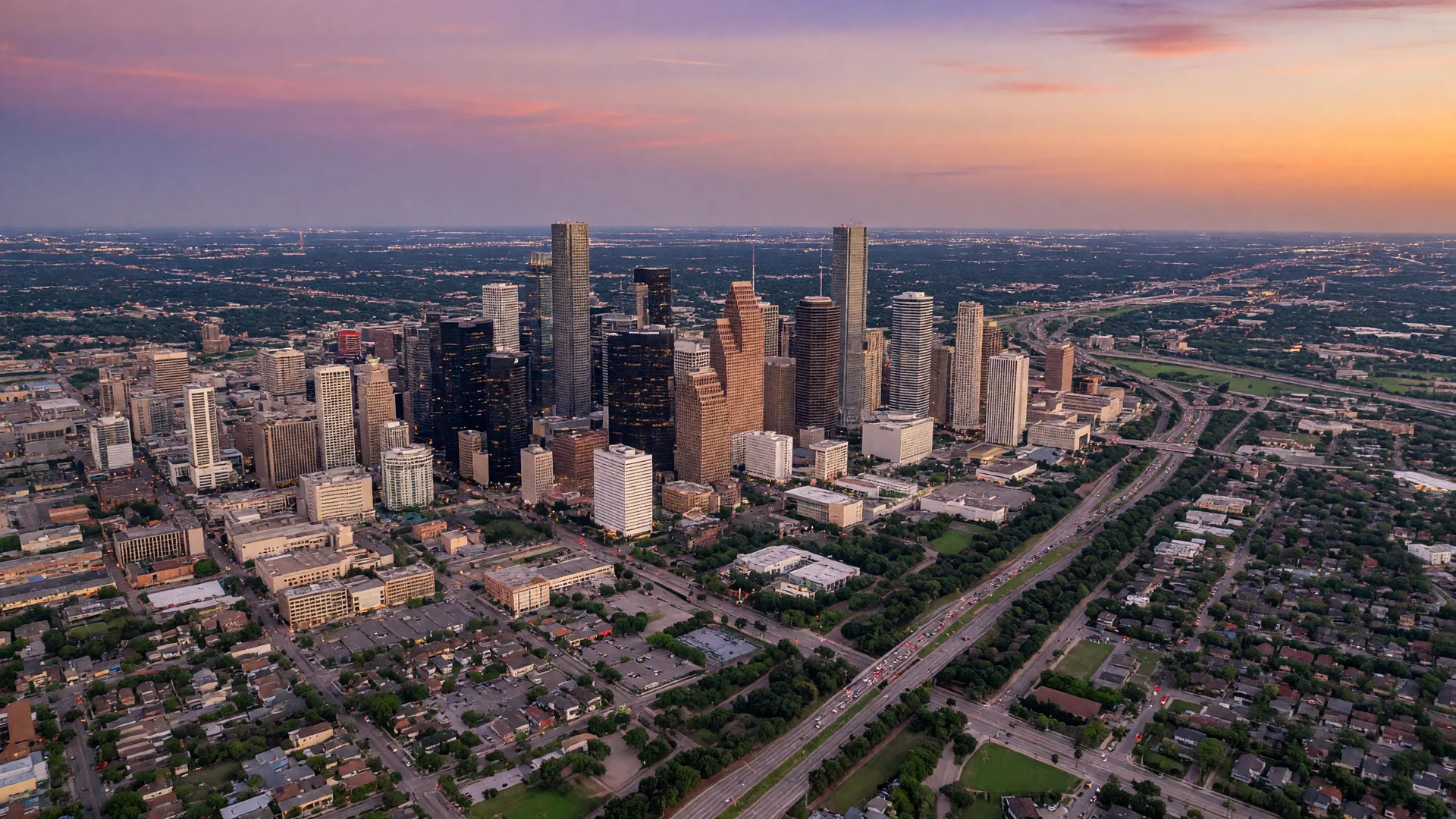 Houston Texas skyline at dusk with towering downtown skyscrapers and wide boulevards