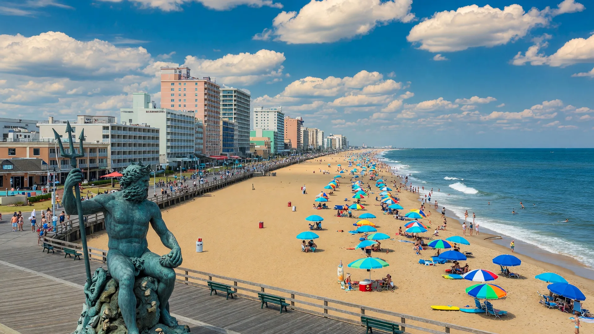 Virginia Beach oceanfront with the iconic boardwalk, Neptune statue, Atlantic Ocean, and resort hotel skyline