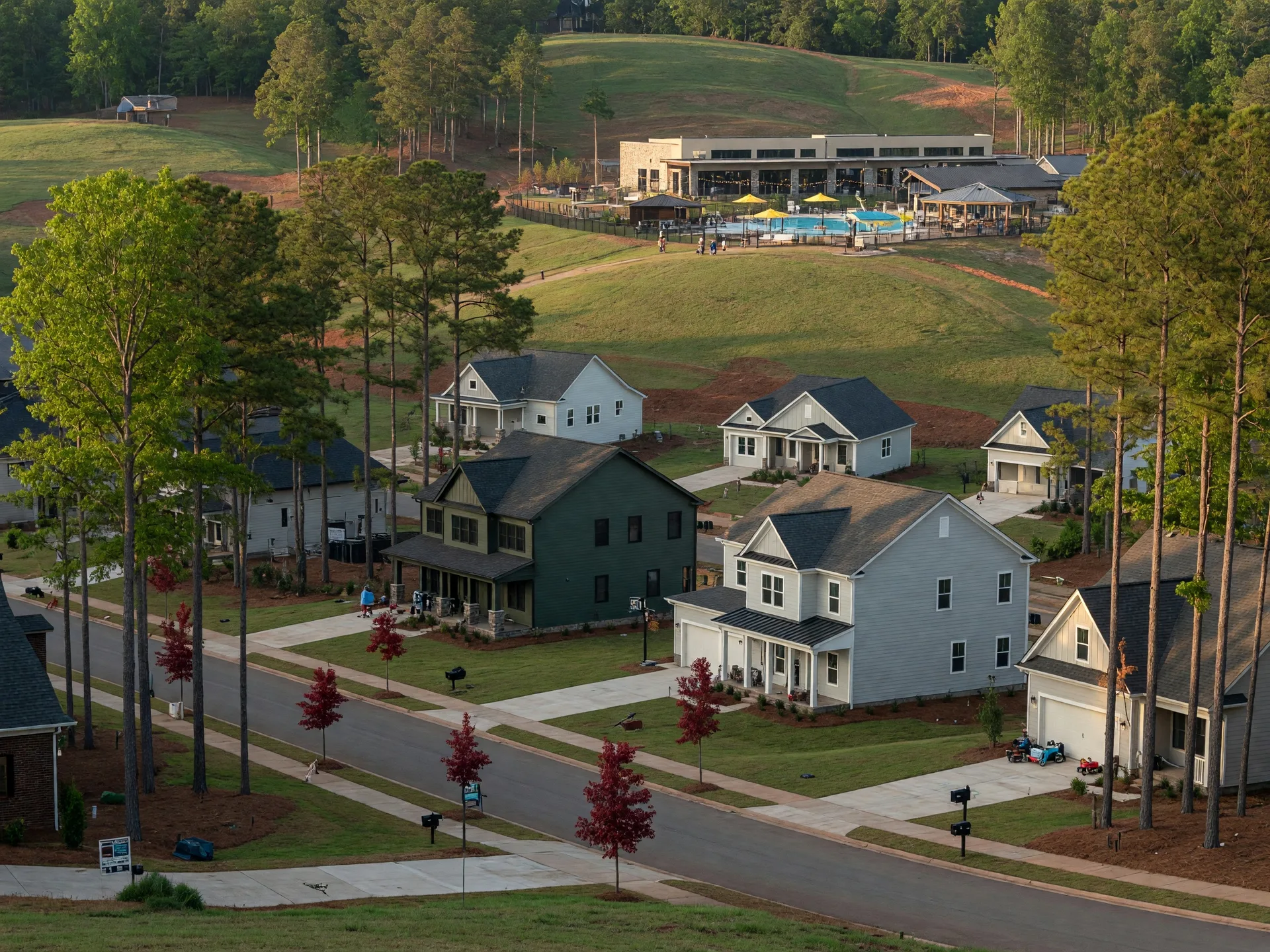 New construction craftsman and transitional homes in a Duluth Gwinnett County master-planned community with mature trees, rolling terrain, and family amenities