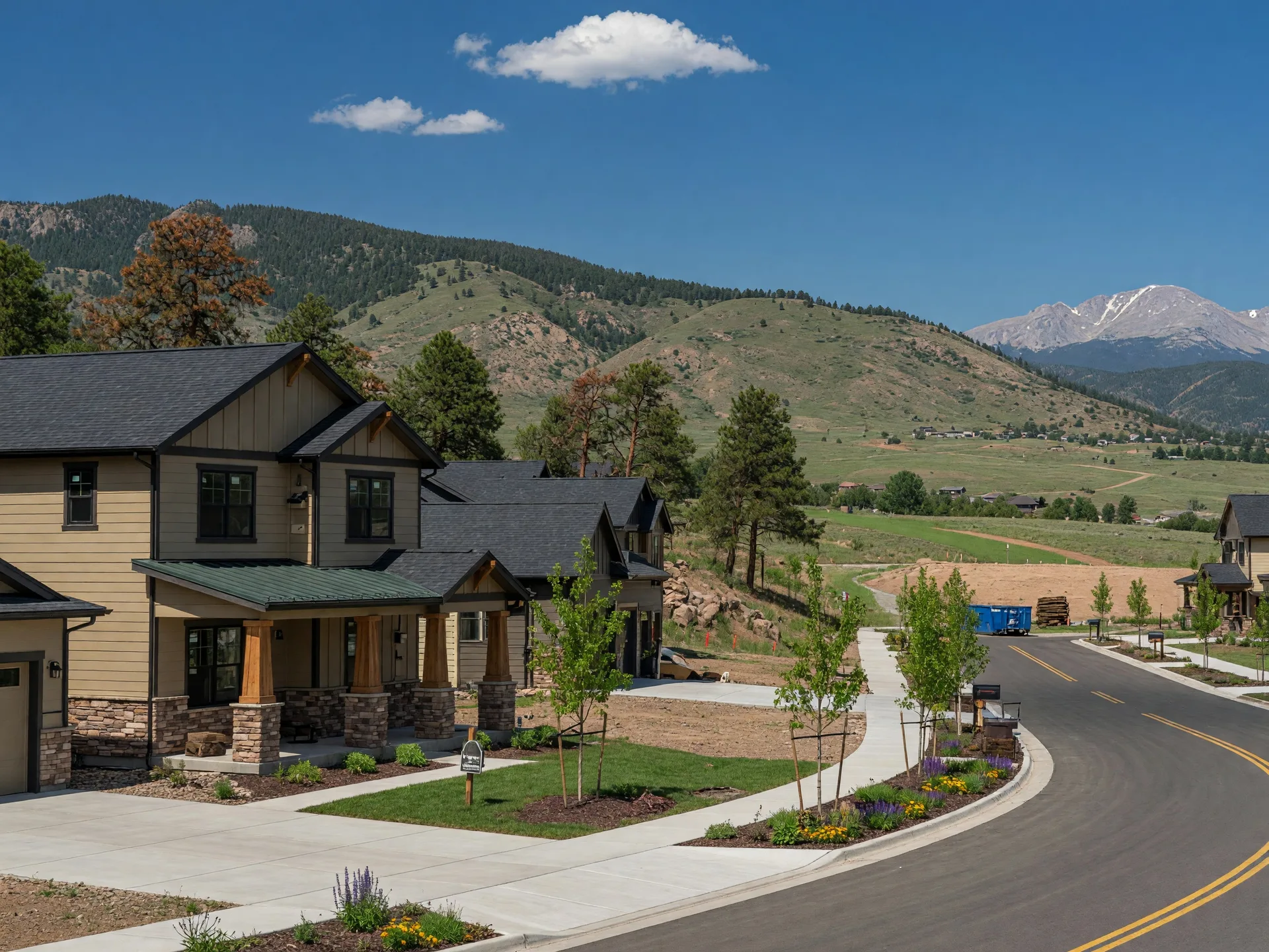 New craftsman-style home in a Loveland master-planned community with Ponderosa pine trees, foothills terrain, and Rocky Mountain views in the distance