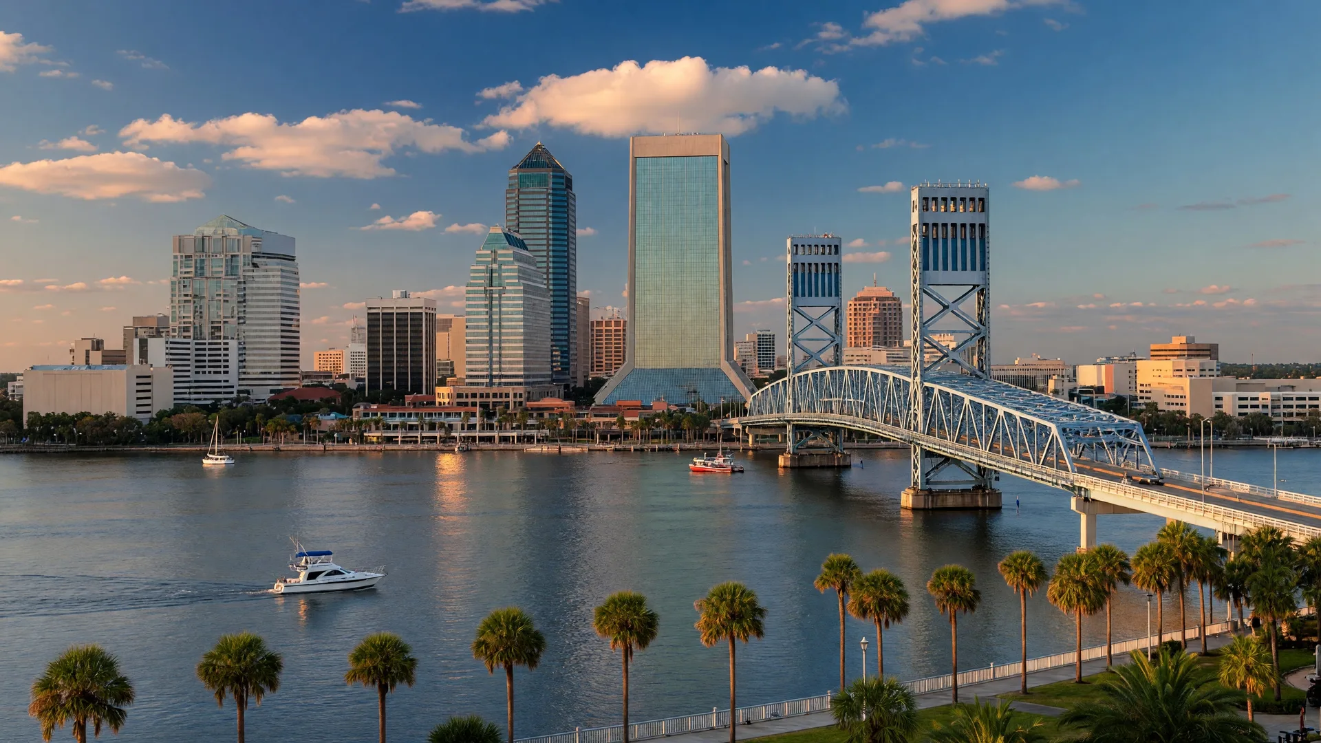 Downtown Jacksonville skyline along the St. Johns River with the Main Street Bridge and riverfront palm trees