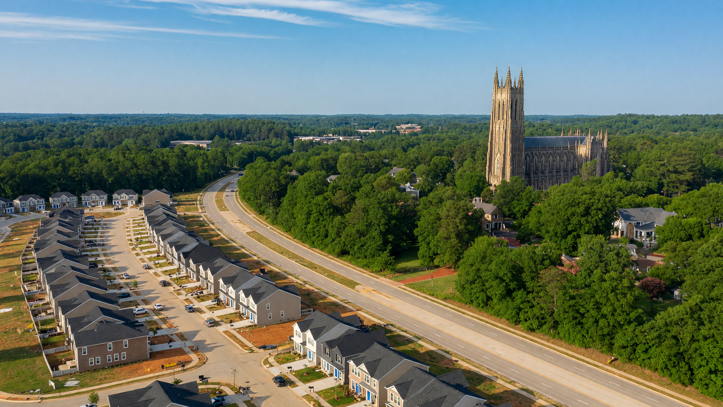 Aerial view of Durham, North Carolina showing Duke University spires surrounded by lush tree canopy and new construction communities