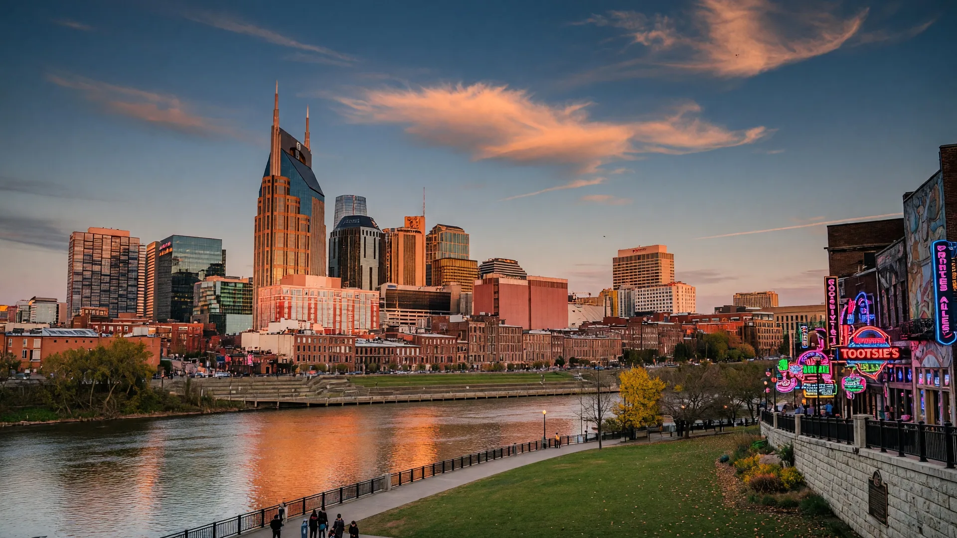 Nashville skyline at golden hour with the Batman Building, Cumberland River, and Nissan Stadium