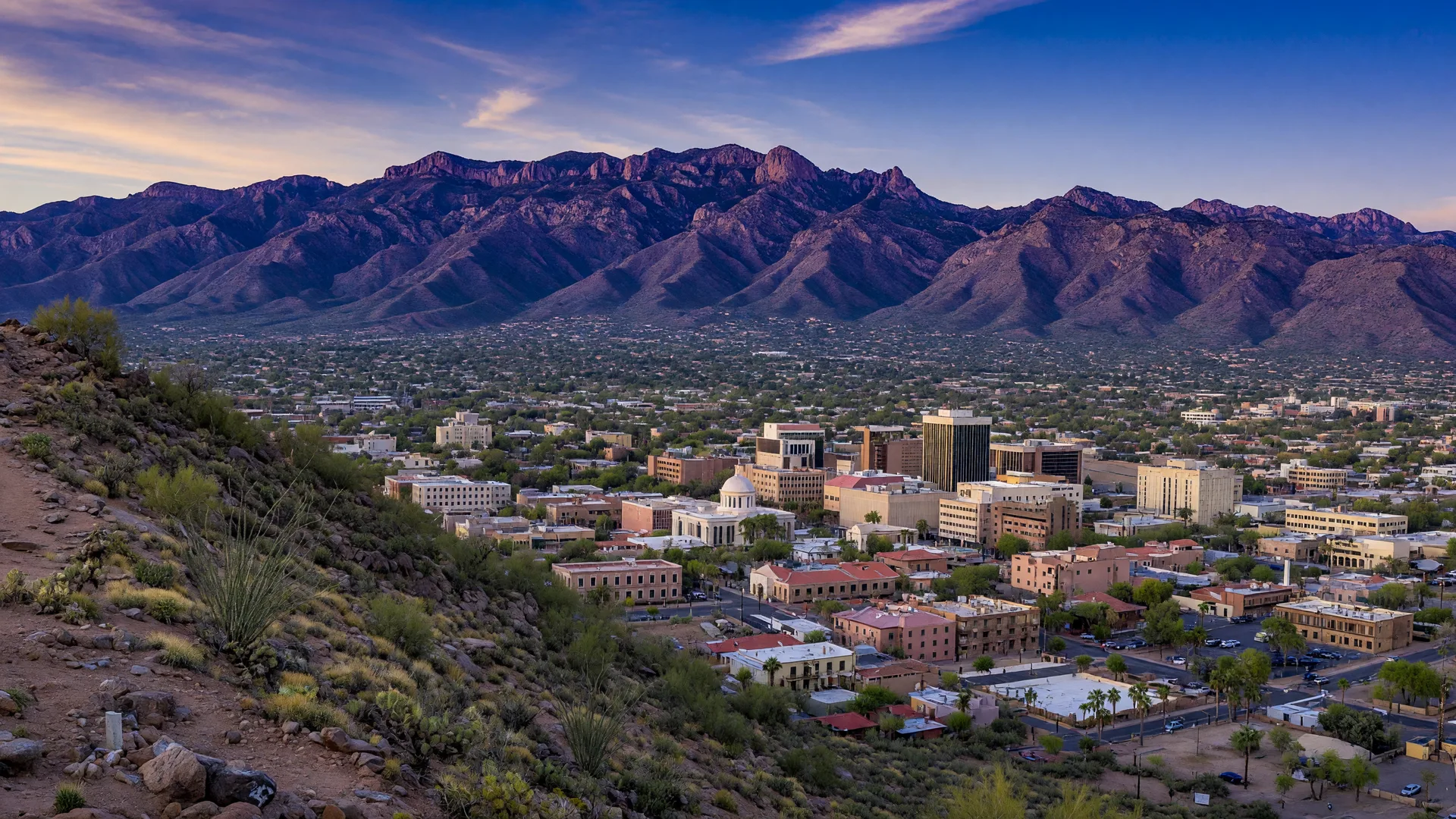 Queen Creek's desert landscape with the San Tan Mountain silhouettes, rural desert community feel transitioning to suburban, southeast valley