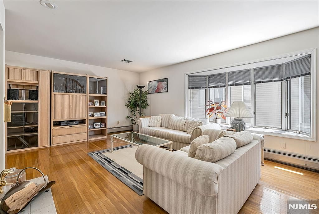 Living room with east-facing bay window, hardwood floors, and natural light