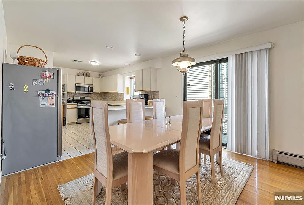 Dining area with view into kitchen and sliding deck door