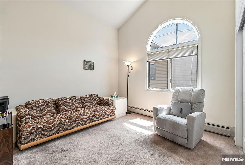 Living room with vaulted ceiling and arched bay window