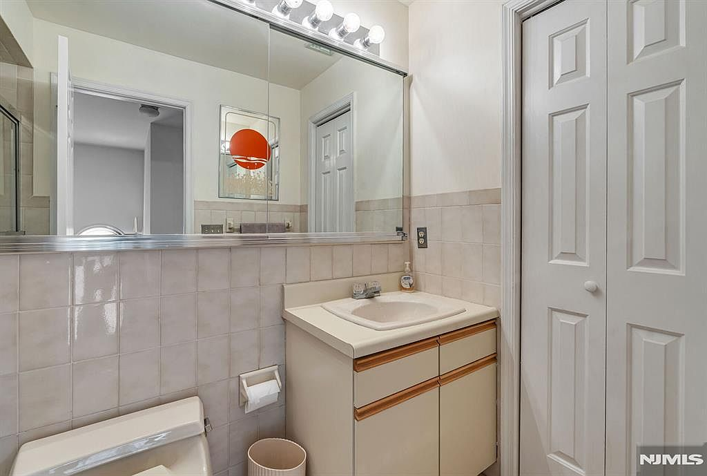 Primary bathroom vanity with large mirror