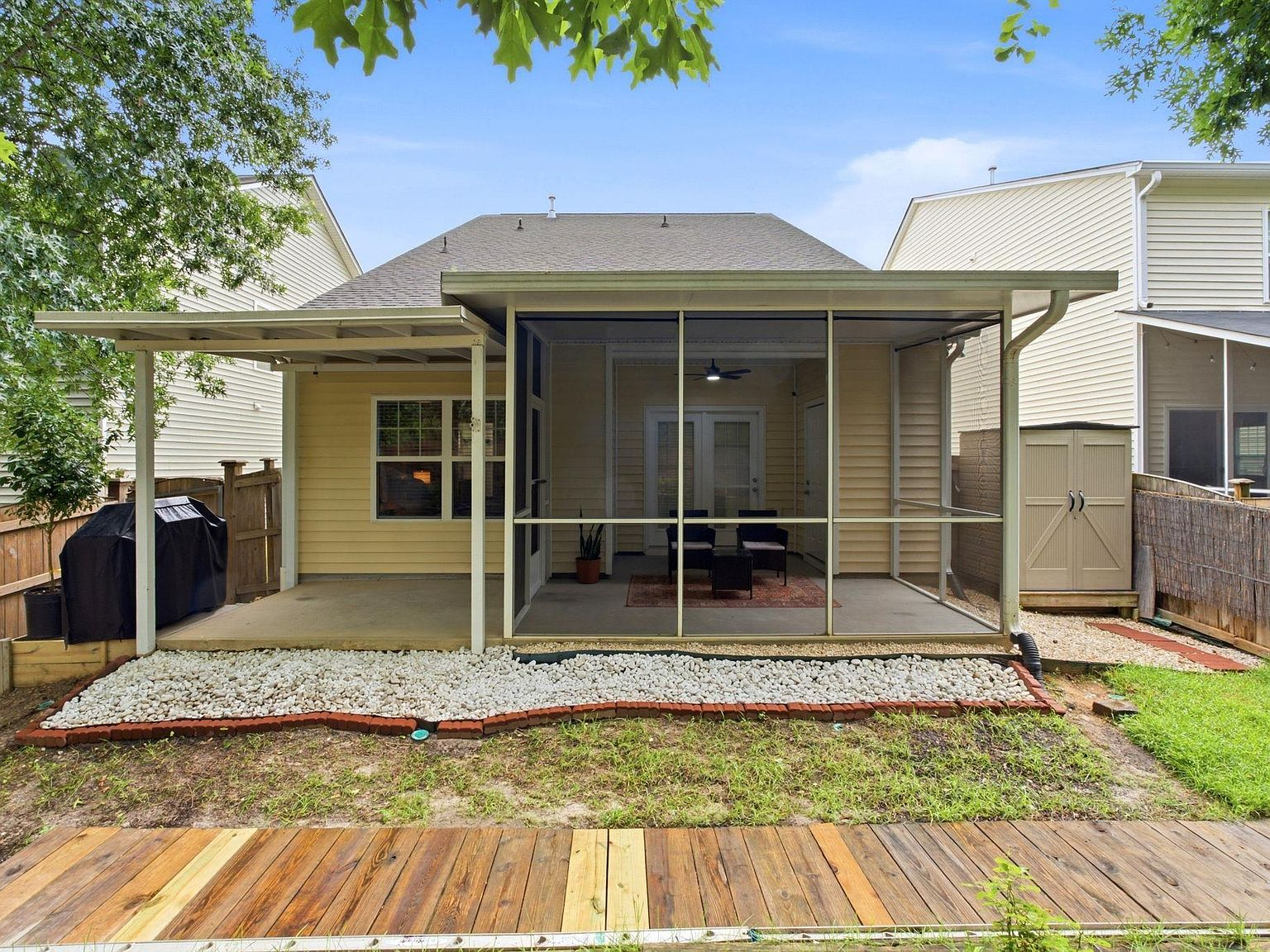 Backyard with screened porch and patio at 157 Autumn Stroll Ct, Lexington SC