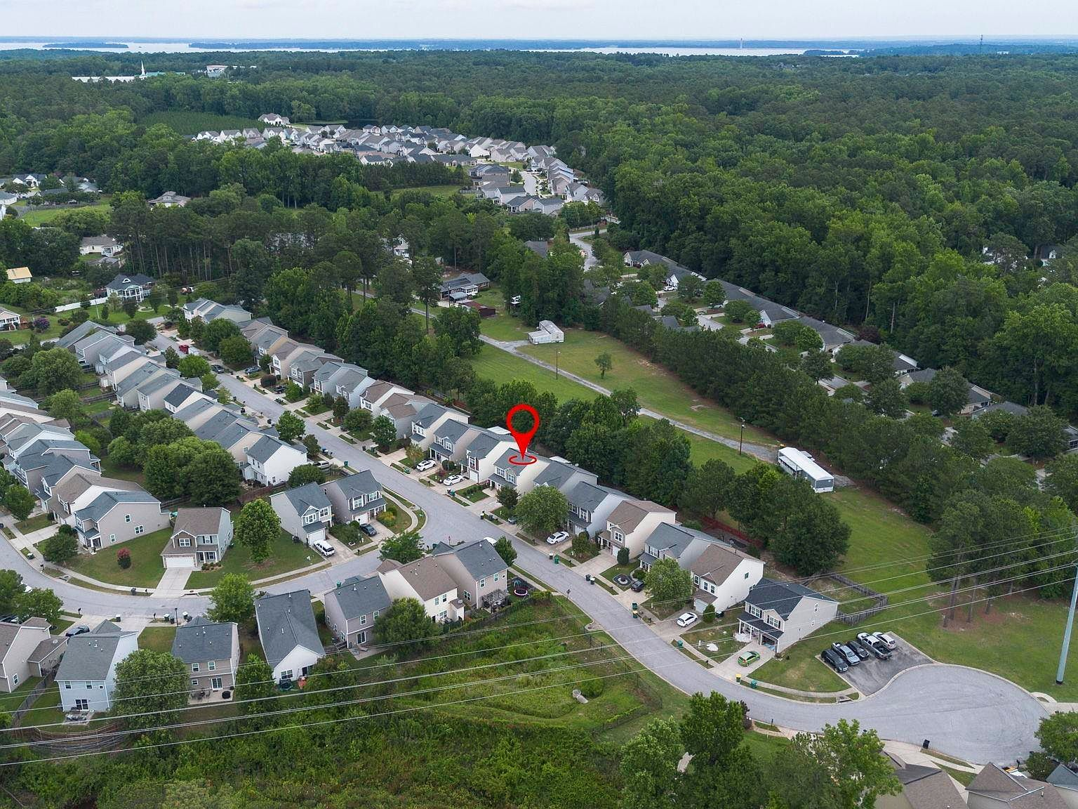 Aerial drone view of the Village of Nightingale neighborhood with tree-lined streets and single-family homes