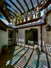 Outdoor courtyard with pergola and seating area