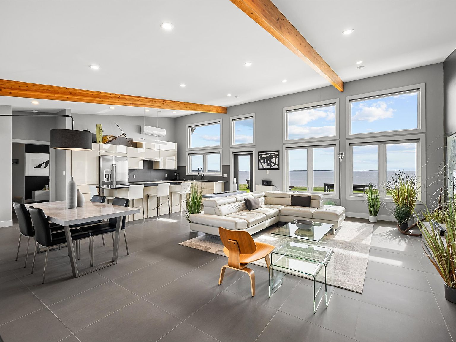 Open-concept living room and kitchen with vaulted ceilings and ocean views