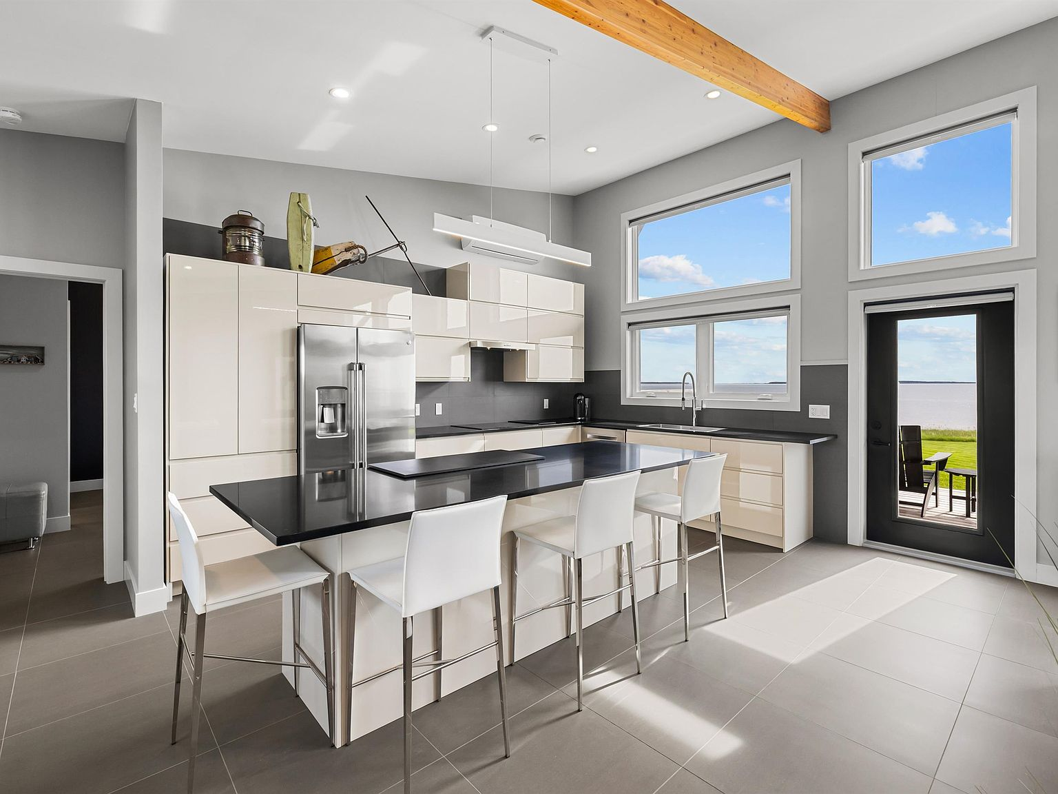 Kitchen with glossy cabinetry and ocean-facing windows