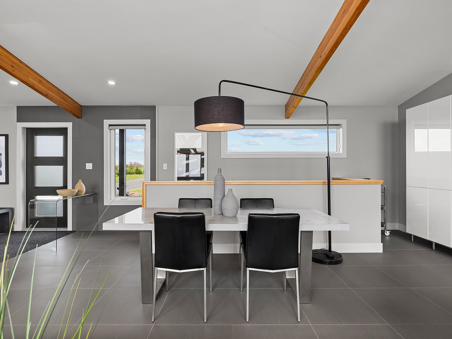 Dining area with exposed beams and porcelain tile flooring