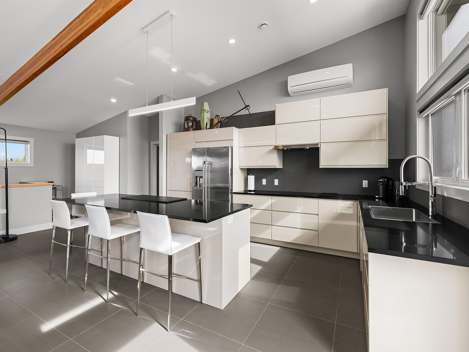 Kitchen with island, bar seating, and vaulted ceiling