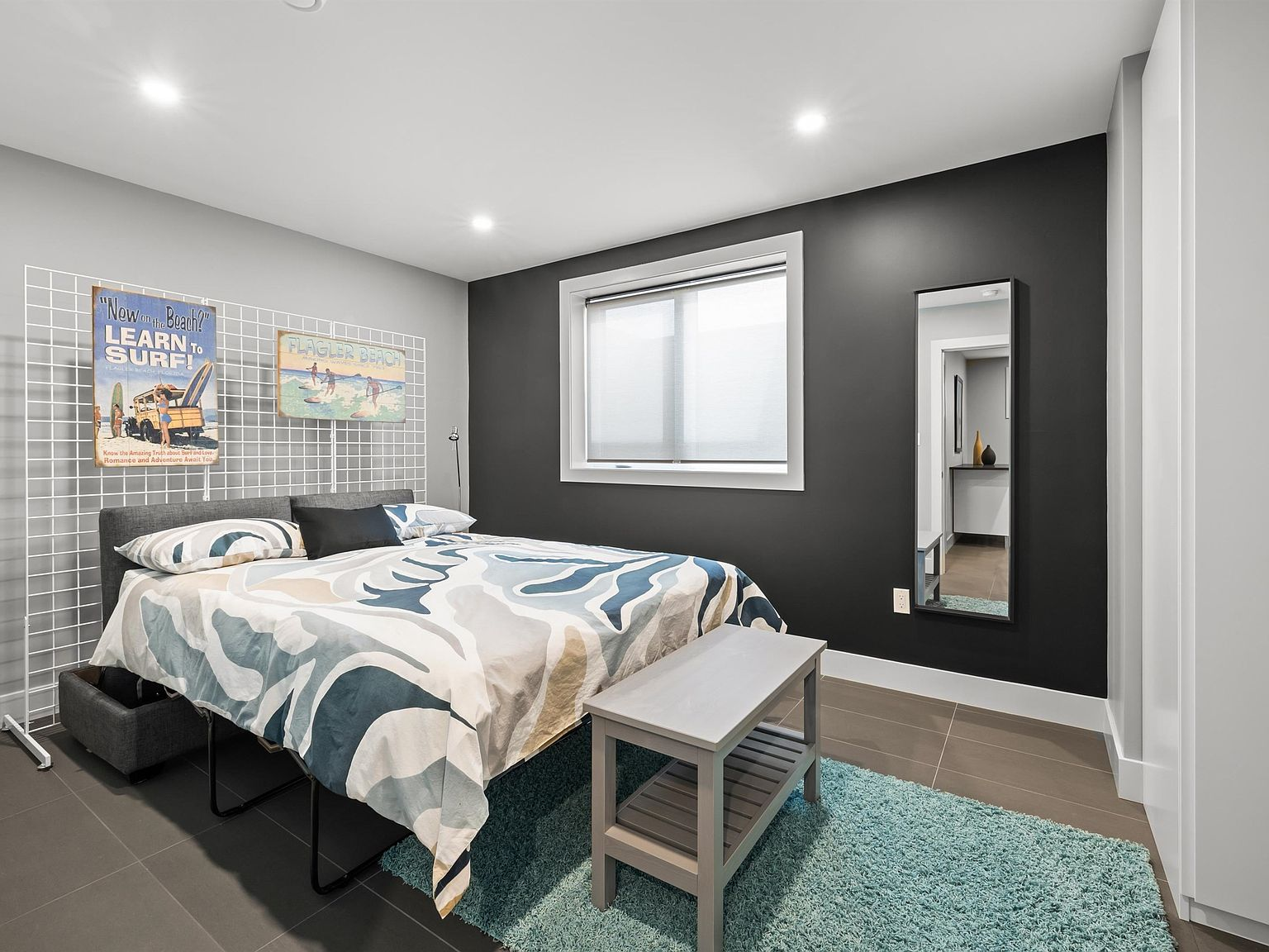Guest bedroom with dark grey accent wall