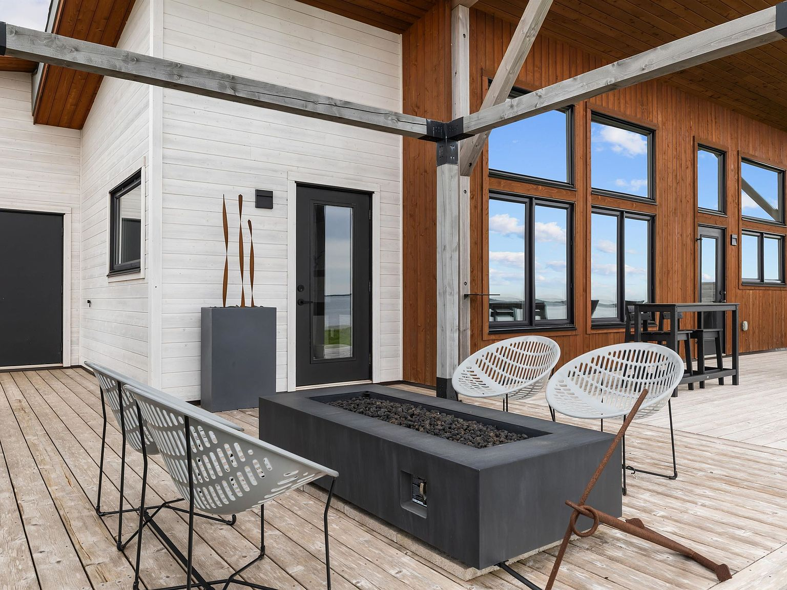 Contemporary cedar deck with outdoor living space overlooking the ocean
