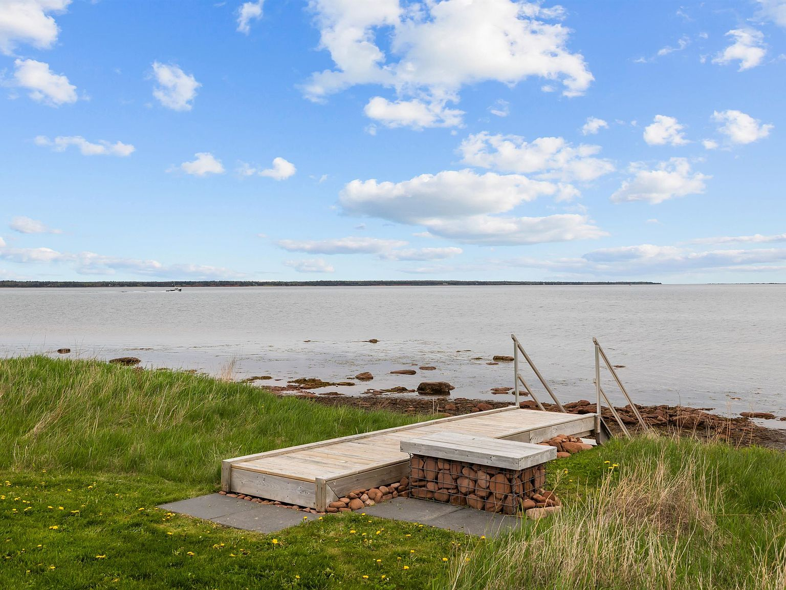 Wooden boardwalk leading to stone stairs at the waterfront