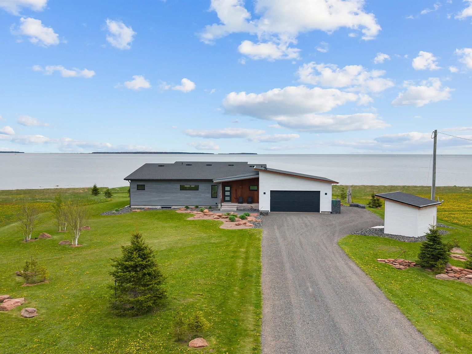 Aerial view of 61 Battery Cres, a contemporary waterfront home in Georgetown, PEI, with panoramic ocean views