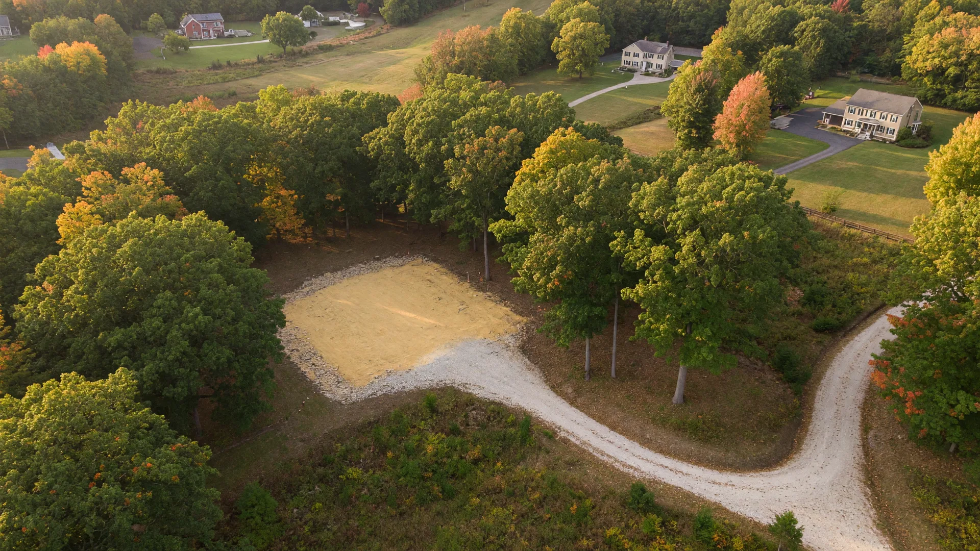Wooded one-acre homesite with mature trees in Tyrone Township, Michigan — an ideal setting for a custom new construction home