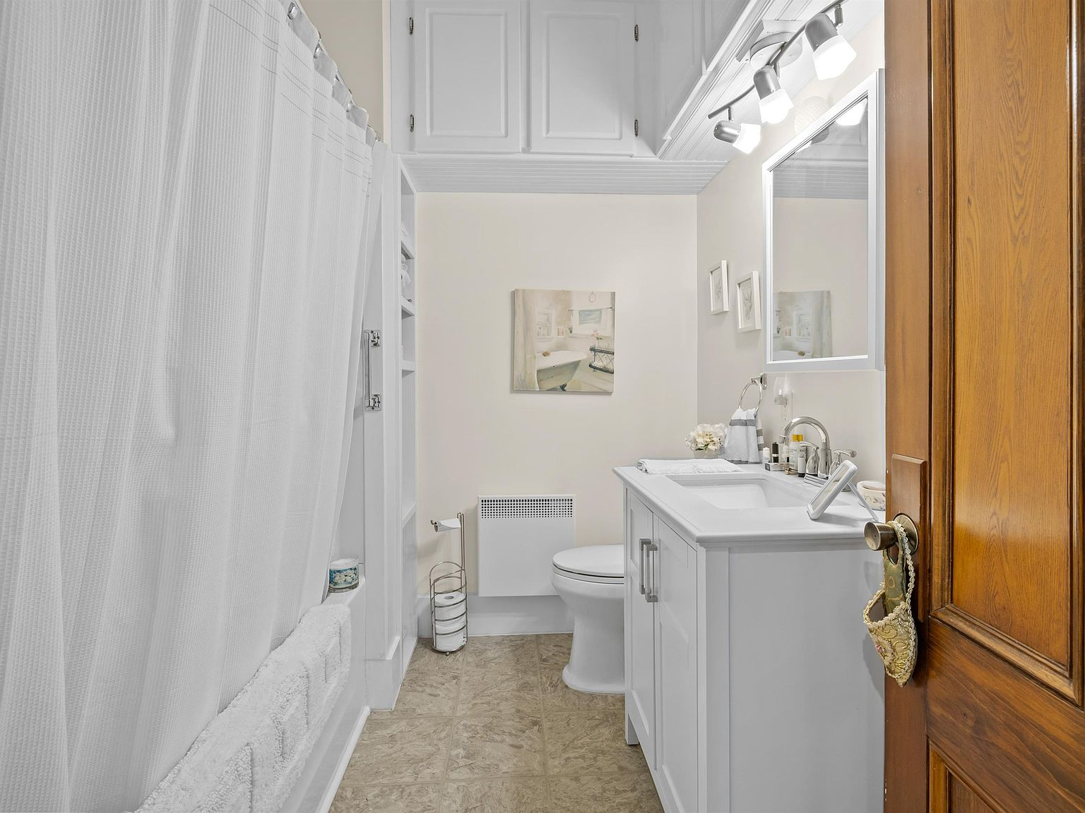 Renovated bathroom with white shaker vanity