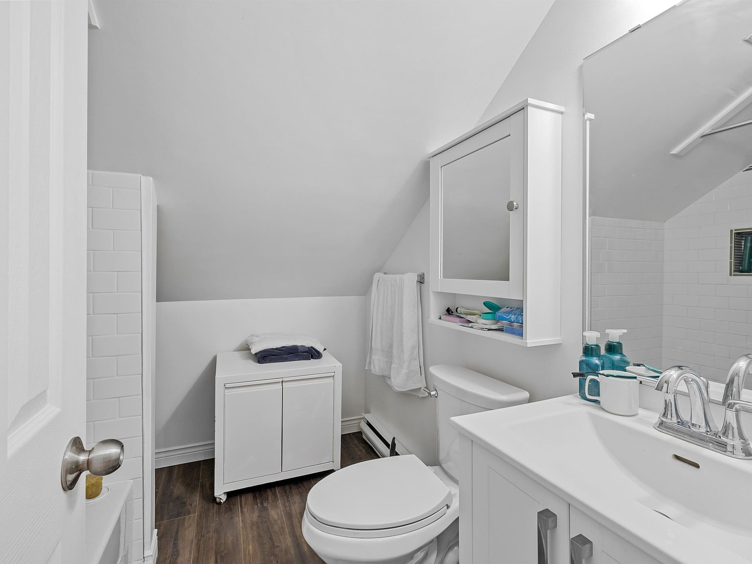 Attic bathroom with white subway tile and modern vanity