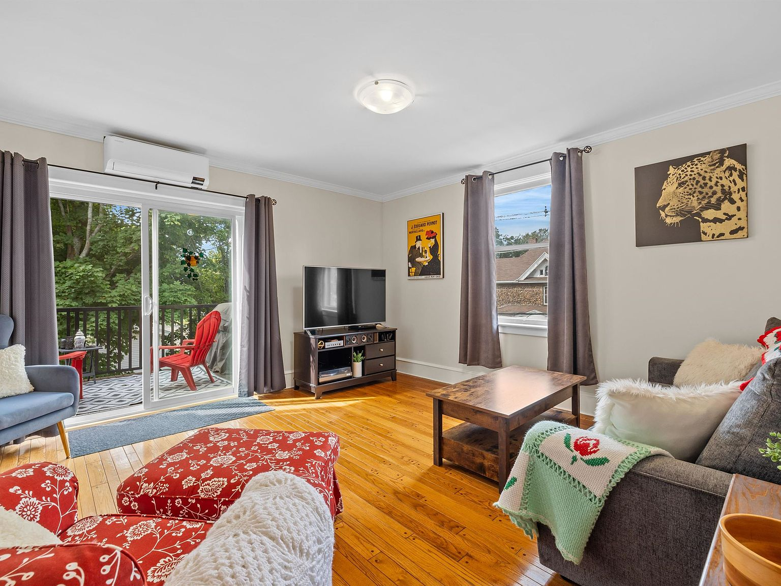 Living room with balcony walkout and hardwood floors