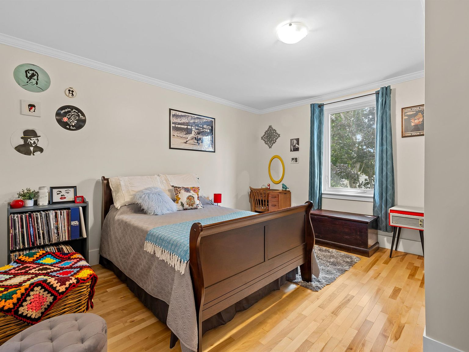 Bedroom with refinished hardwood and neutral paint