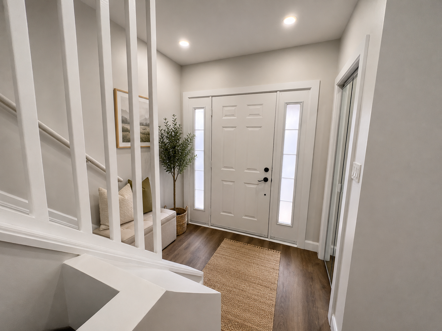 Foyer entrance with white trim, grey walls, and recessed pot lights