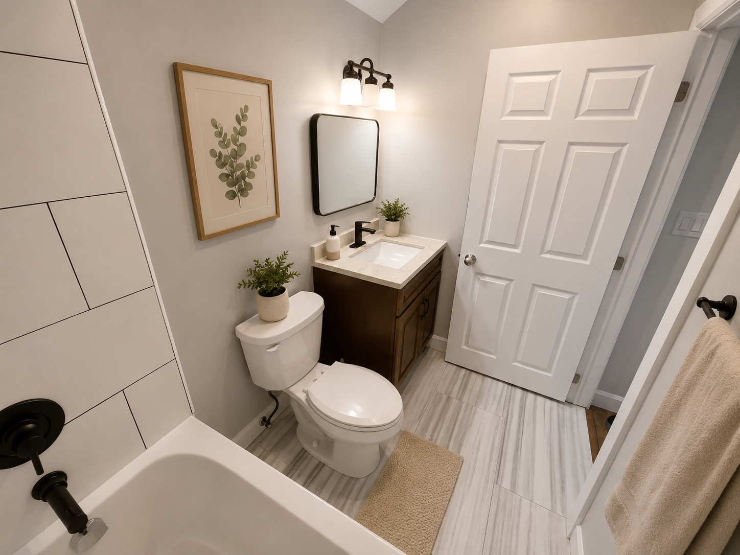 Modern bathroom with subway tile shower surround and matte black fixtures