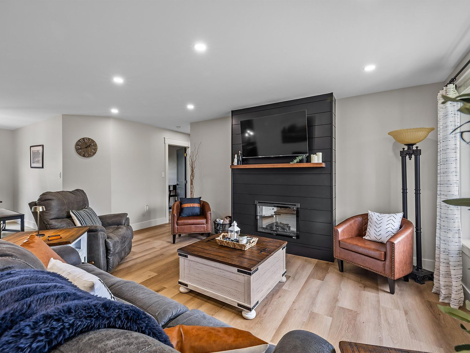 Living room with black shiplap fireplace feature wall