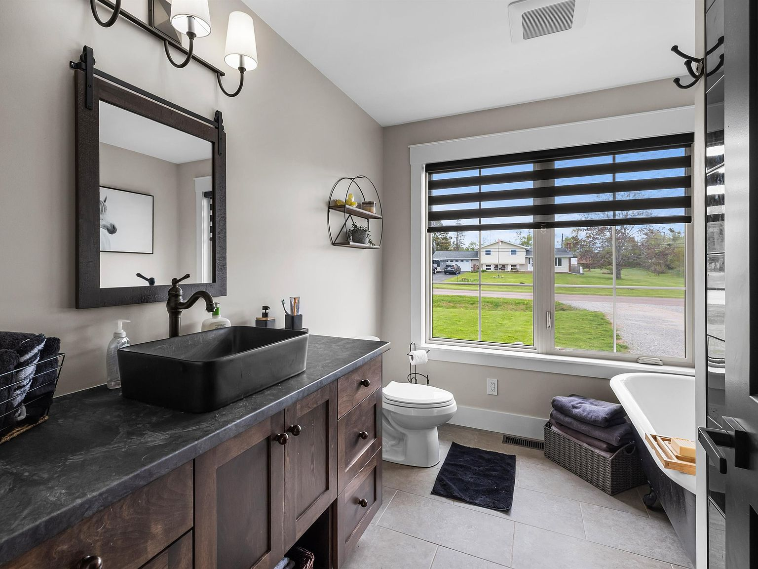 Primary ensuite bathroom with freestanding clawfoot tub