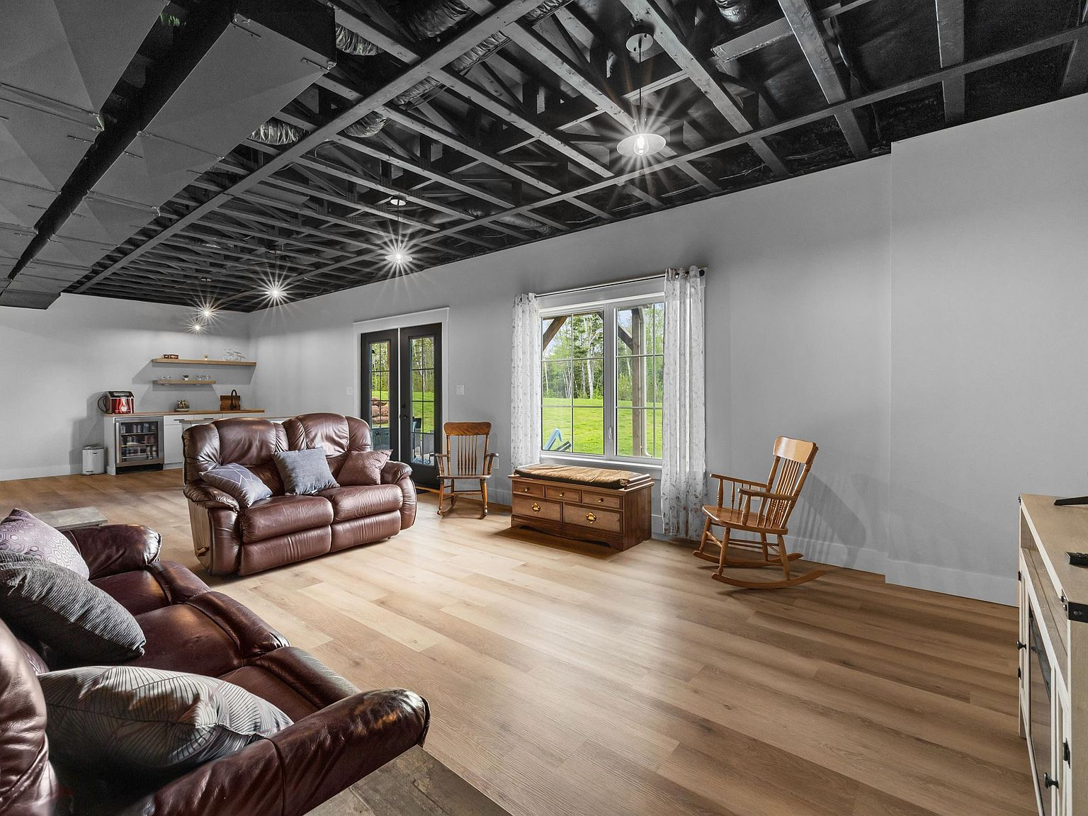Walk-out lower level recreation room with 10-foot exposed ceilings