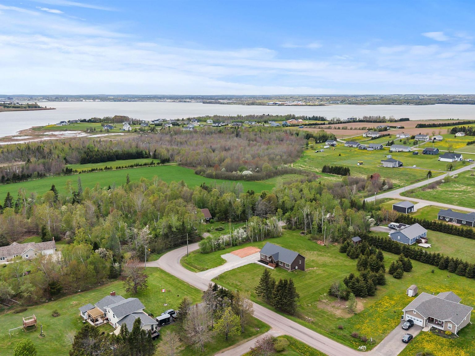 Aerial drone view of the property showing proximity to water inlet and surrounding landscape