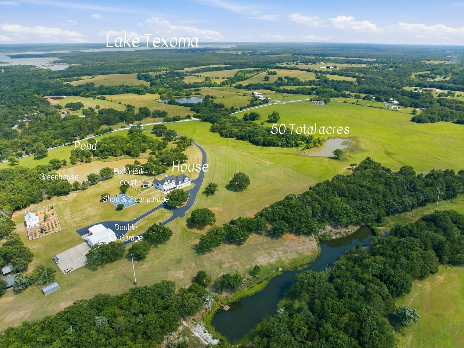Aerial view looking north toward Lake Texoma with farmhouse, workshop, and greenhouse visible