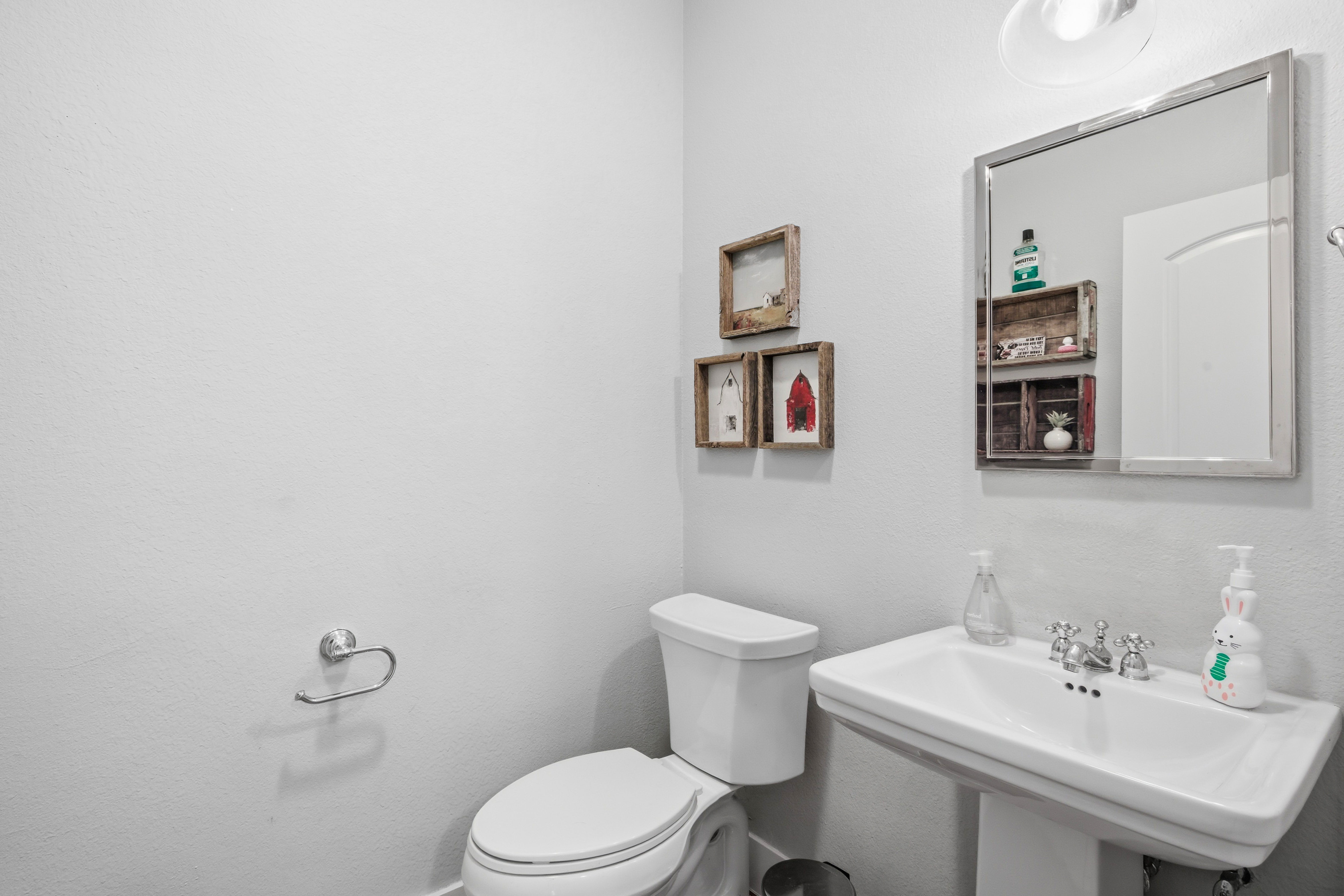 Powder room with pedestal sink and transitional style