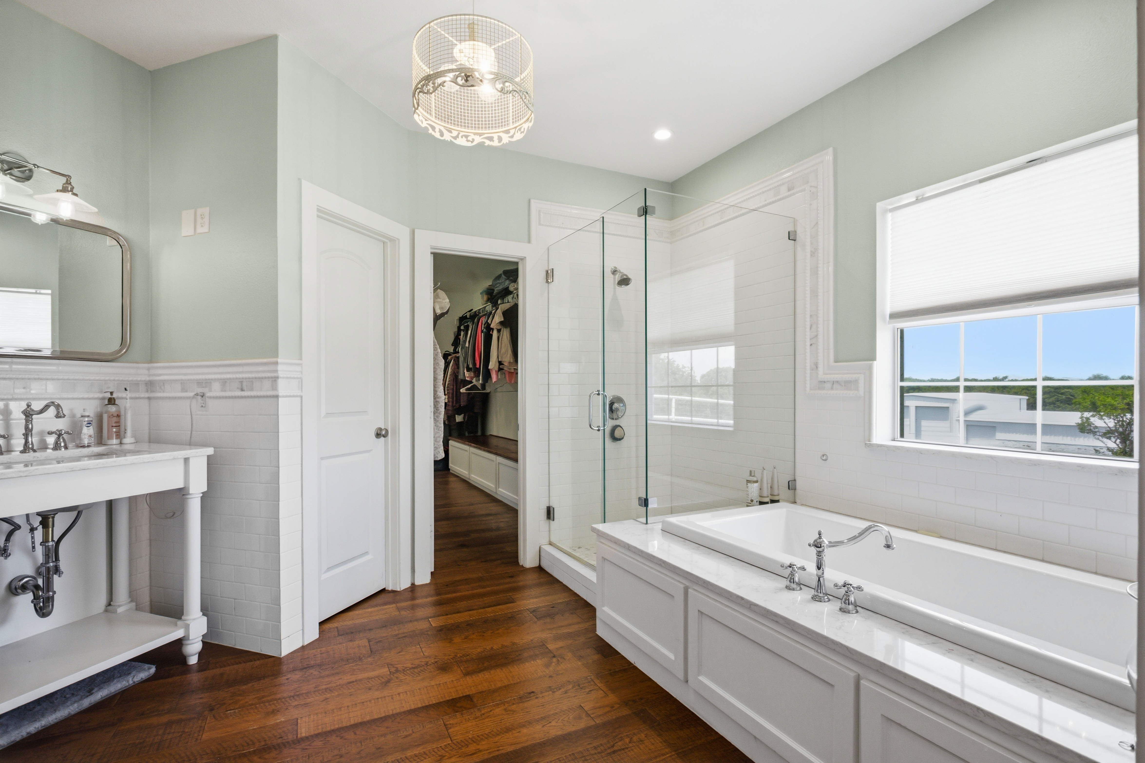 Primary bathroom en suite with marble details and natural daylight