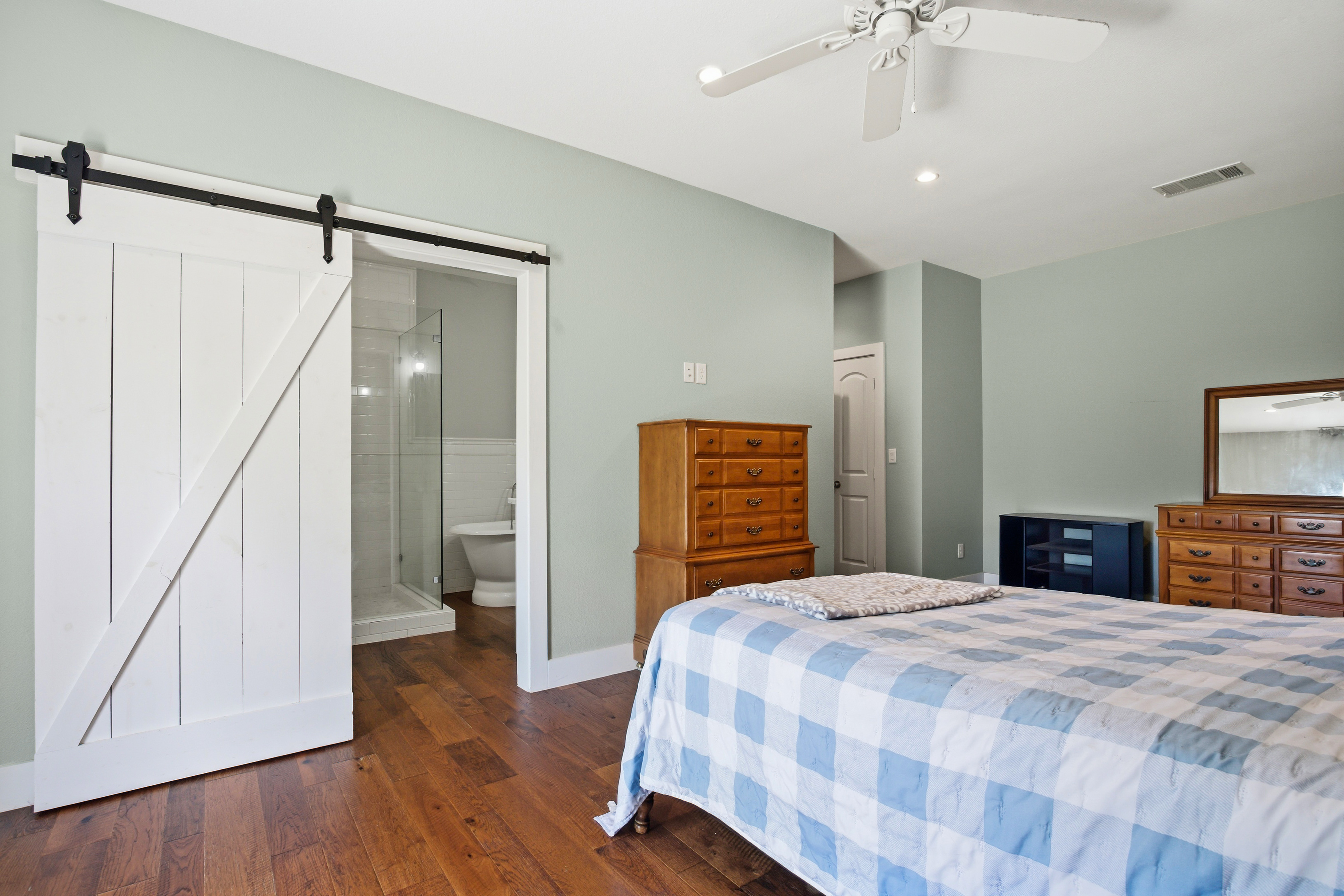 Bedroom with sliding barn door on black tracks
